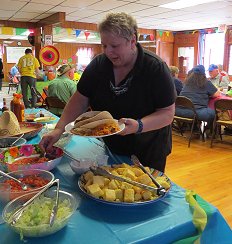 Connie helps herself to pico de gallo at the taco toppings bar.
