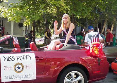 The 2014 Miss Poppy, Lacey, rode in the parade in a Mustang.