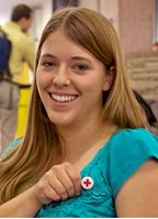 American Red Cross blood donor with pin.